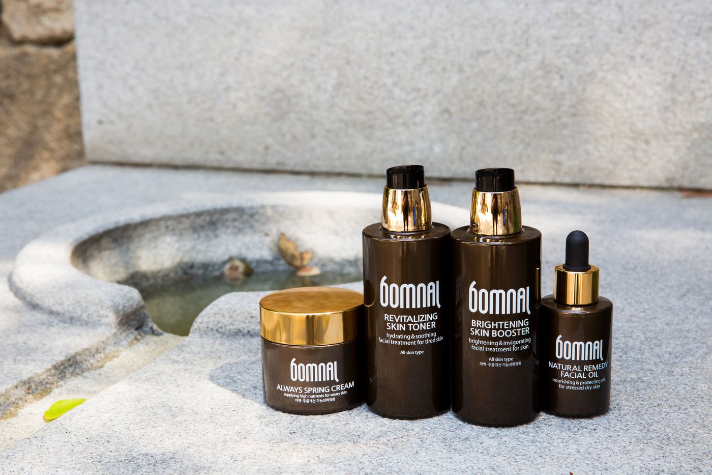 Skincare products on a stone surface